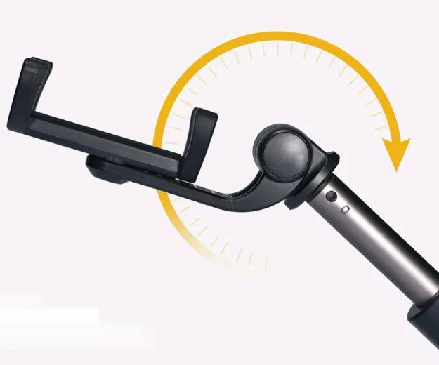 Aluminium telescopic Bluetooth selfie stick with tripod base and remote control next to a smartphone.