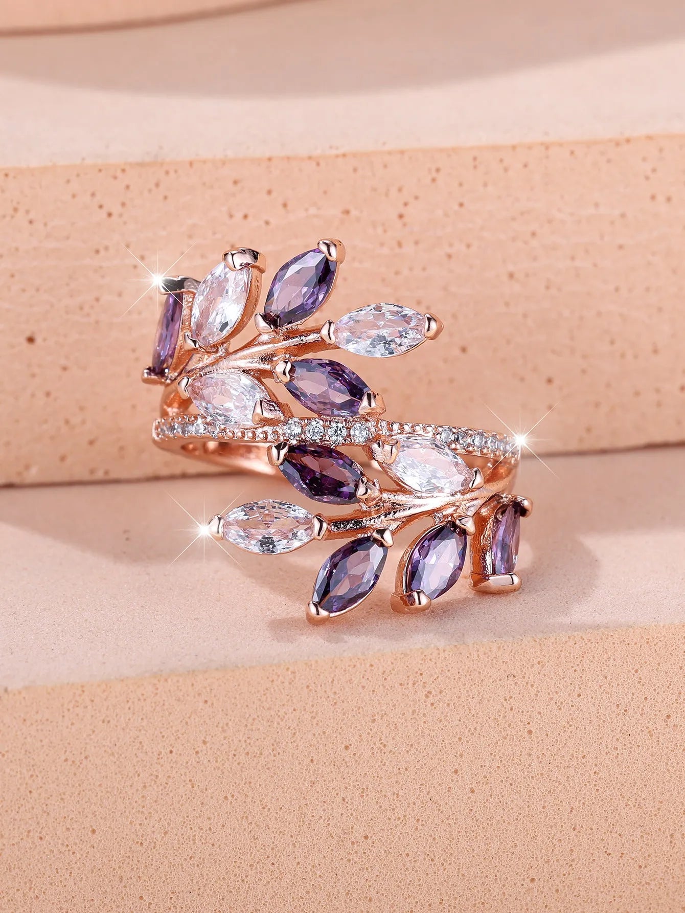Adjustable copper leaf ring with a zircon stone in a choice of rose gold or platinum finishes.