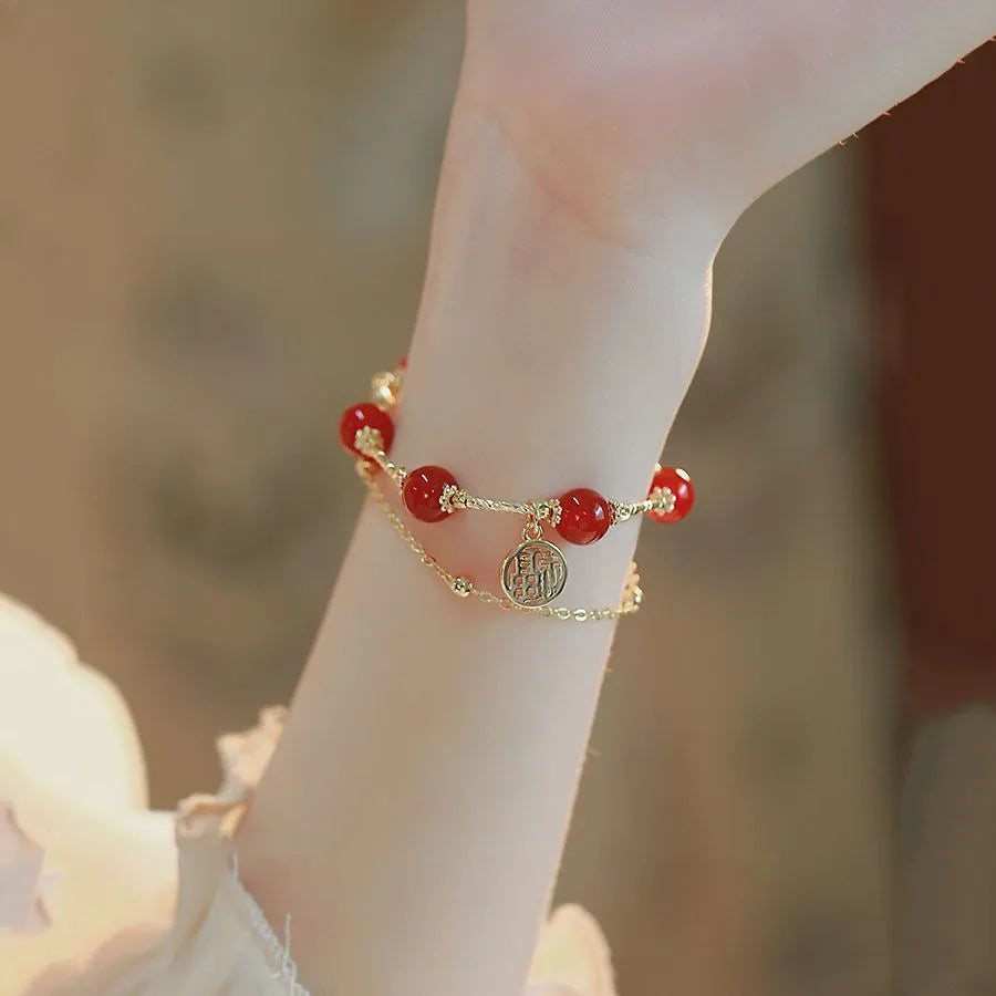 Red agate and alloy double-layer women's bracelet with a Red Horse blessing card charm on a white background.