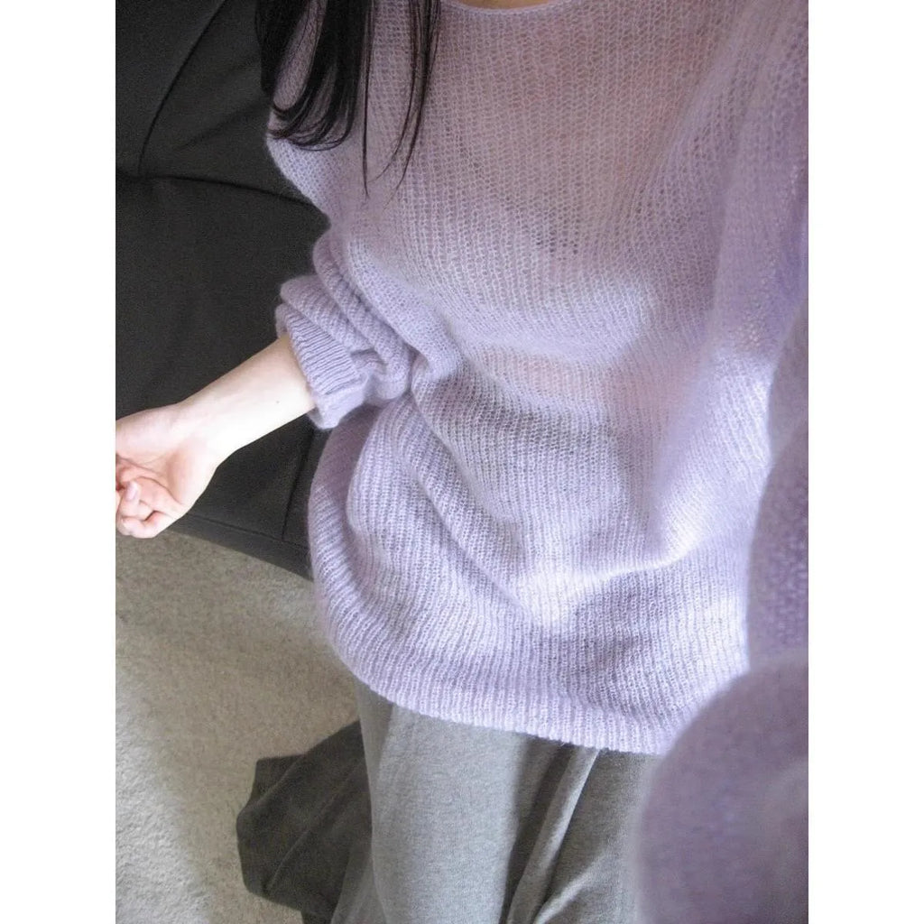 Purple women's sleeveless blouse with hollow out detail and princess sleeves, laid flat.