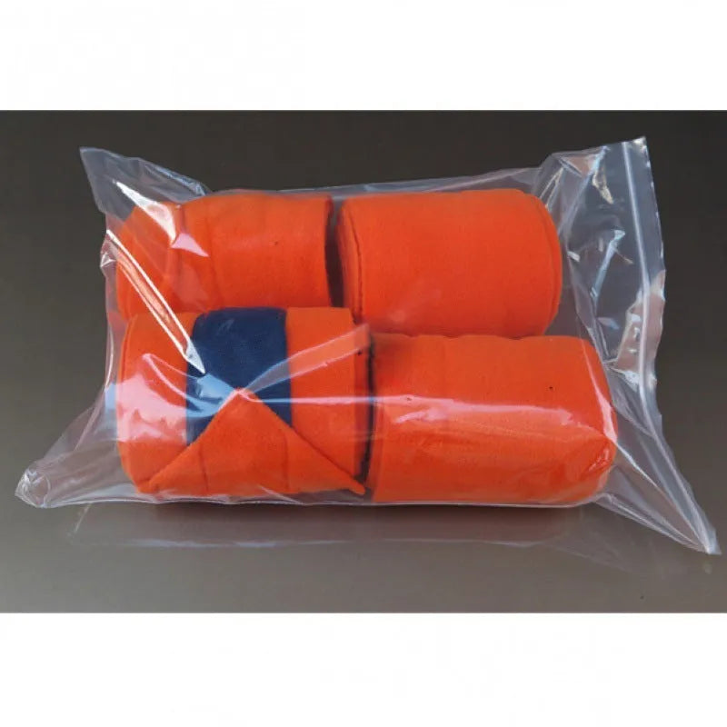 Set of four thick fleece double-sided plush horse leg guards in assorted colours on a stable floor