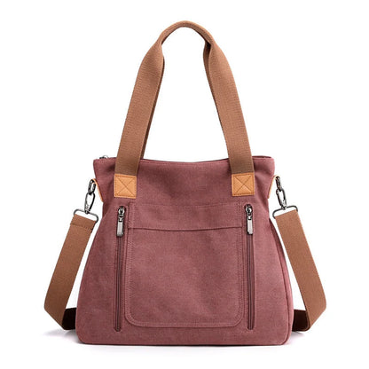 Women's canvas shoulder bag in multiple colours, showcasing spacious interior and zipper closure.