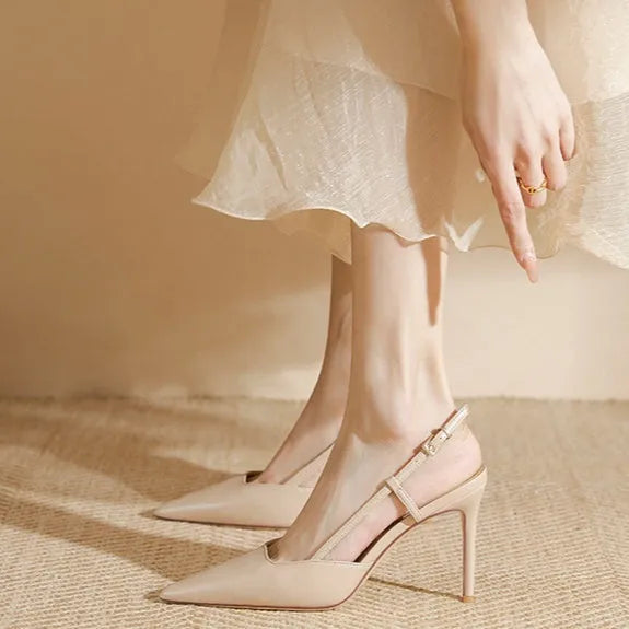 Apricot coloured women's high-heeled sandals with a single strap and buckle on a rubber sole.