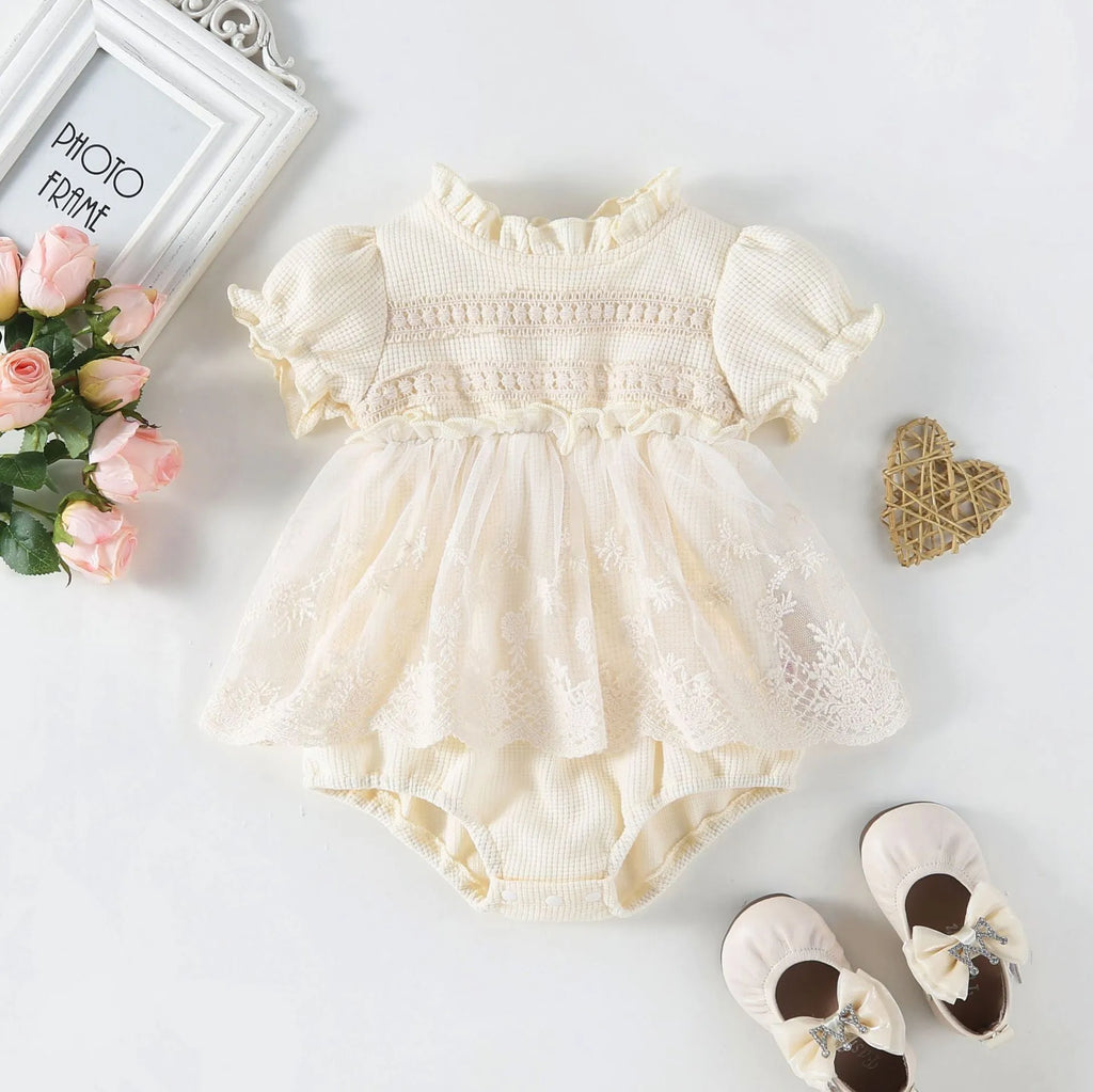 Apricot cotton triangle jumpsuit for girls with short sleeves and single-breasted closure on a white background