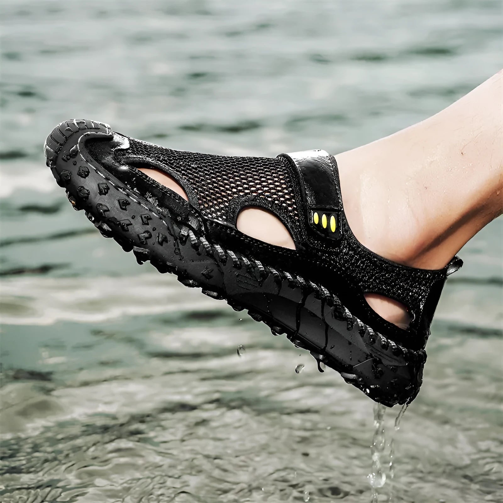 Men's black casual sandals with a mesh upper and velcro strap on a rubber sole.