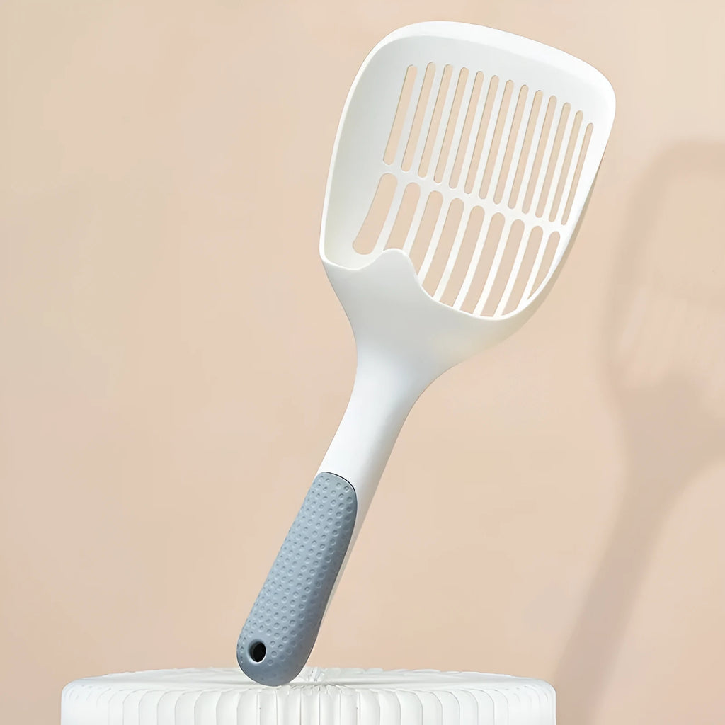 White plastic cat litter scoop with storage base for litter tray cleaning