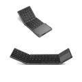 Black tri-fold Bluetooth keyboard shown open next to a smartphone, demonstrating its portable size.