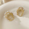 Gold-coloured copper flower basket earrings with small rice-shaped beads and pearl inlay details