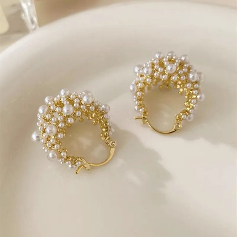 Gold-coloured copper flower basket earrings with small rice-shaped beads and pearl inlay details