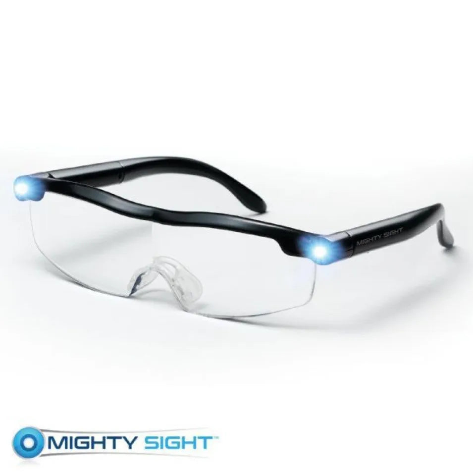 Transparent black USB LED reading glasses with ABS frame on a surface.