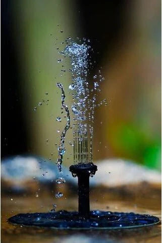 Solar Water Mercury Garden Miniature Floating Fountain with adjustable sprays in a garden setting