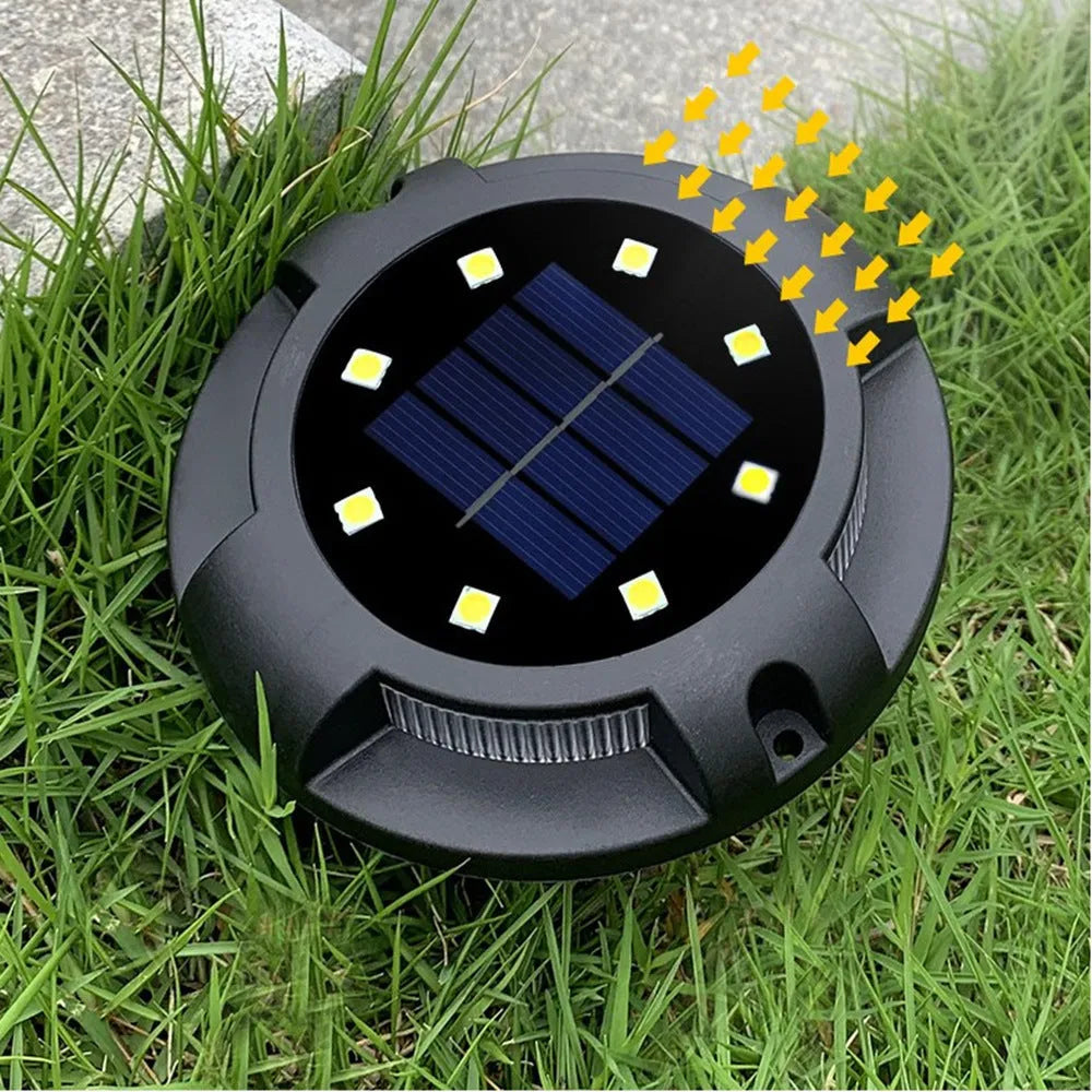 LED solar underground lawn light 11x4x13cm black ABS PP with seven colour changing cold white light on grass at dusk