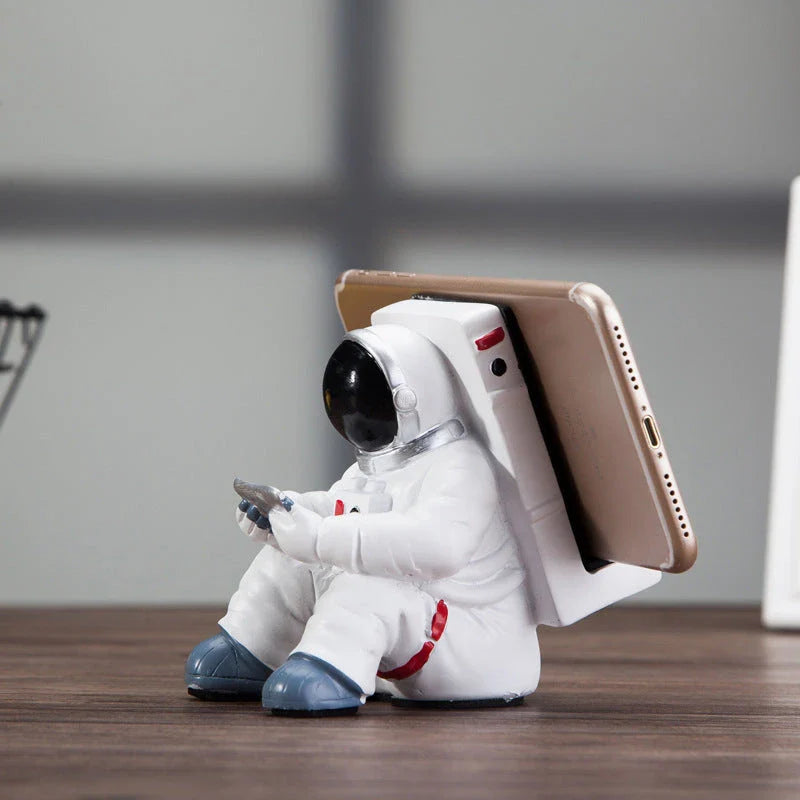 Astronaut-themed resin phone stand with unique design for desk decoration