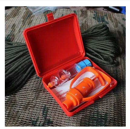 Orange portable first aid suction device for venom extraction, shown with two suction cups, a tourniquet, and swabs.