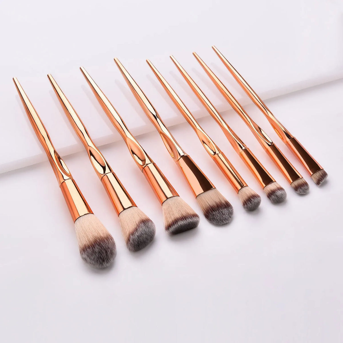 8-piece makeup brush set with nylon bristles, rose gold heart type handles, 22cm long, gold colour