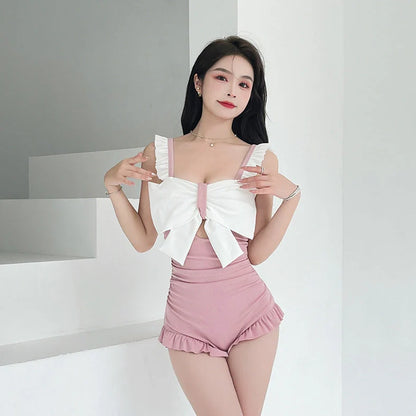 Women's one-piece swimsuit with adjustable bow detailing in solid colour