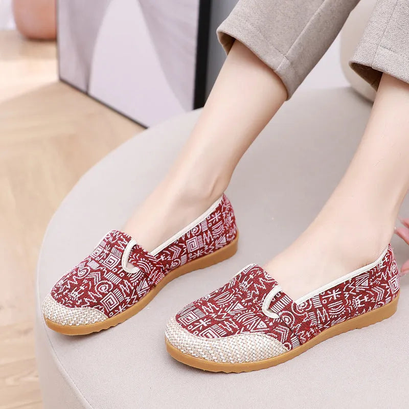 Women's flat heel ethnic cloth shoes in blue with colour stitching detail on a low-top, shallow mouth design.