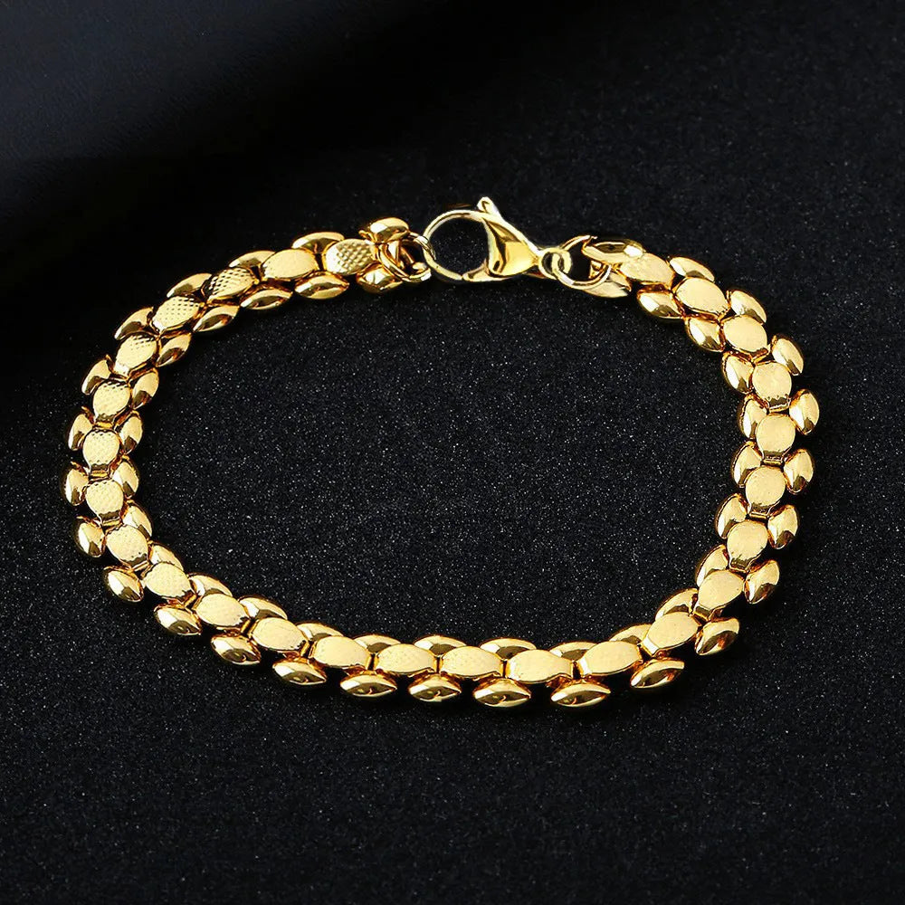 L254 Gold iron bracelet laid flat on a surface, showing its metallic finish and simple design.