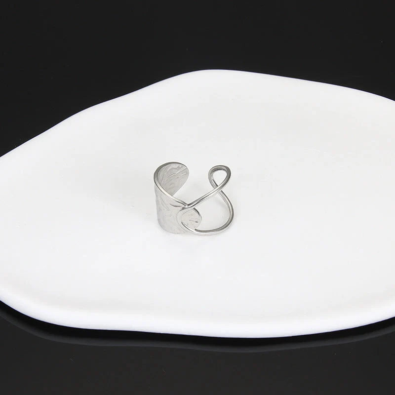 Adjustable stainless steel finger ring with unique charm designs in steel and gold colours