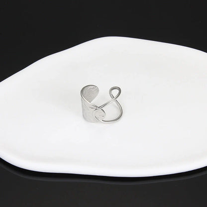 Adjustable stainless steel finger ring with unique charm designs in steel and gold colours