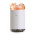 Ultrasonic humidifier diffuser with crystal salt stone and LED lamp in white finish on a desk with USB cable