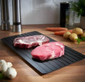 Black aluminium kitchen defrosting tray for thawing frozen food without electricity