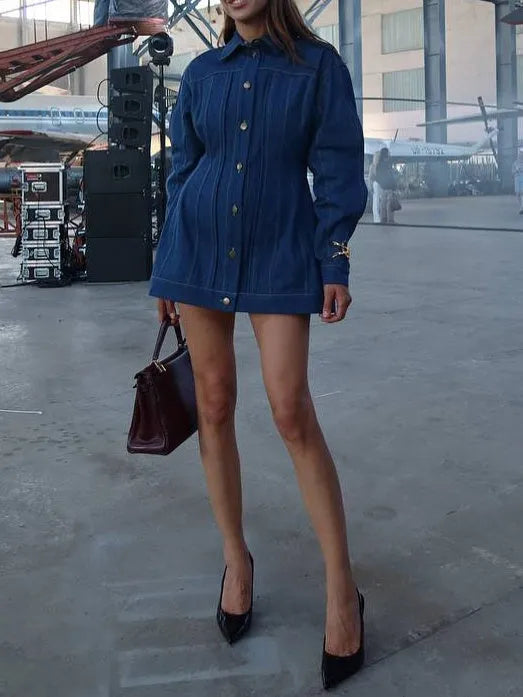 Blue denim corset-style shirt dress with patchwork design and statement buttons on a model, mini length