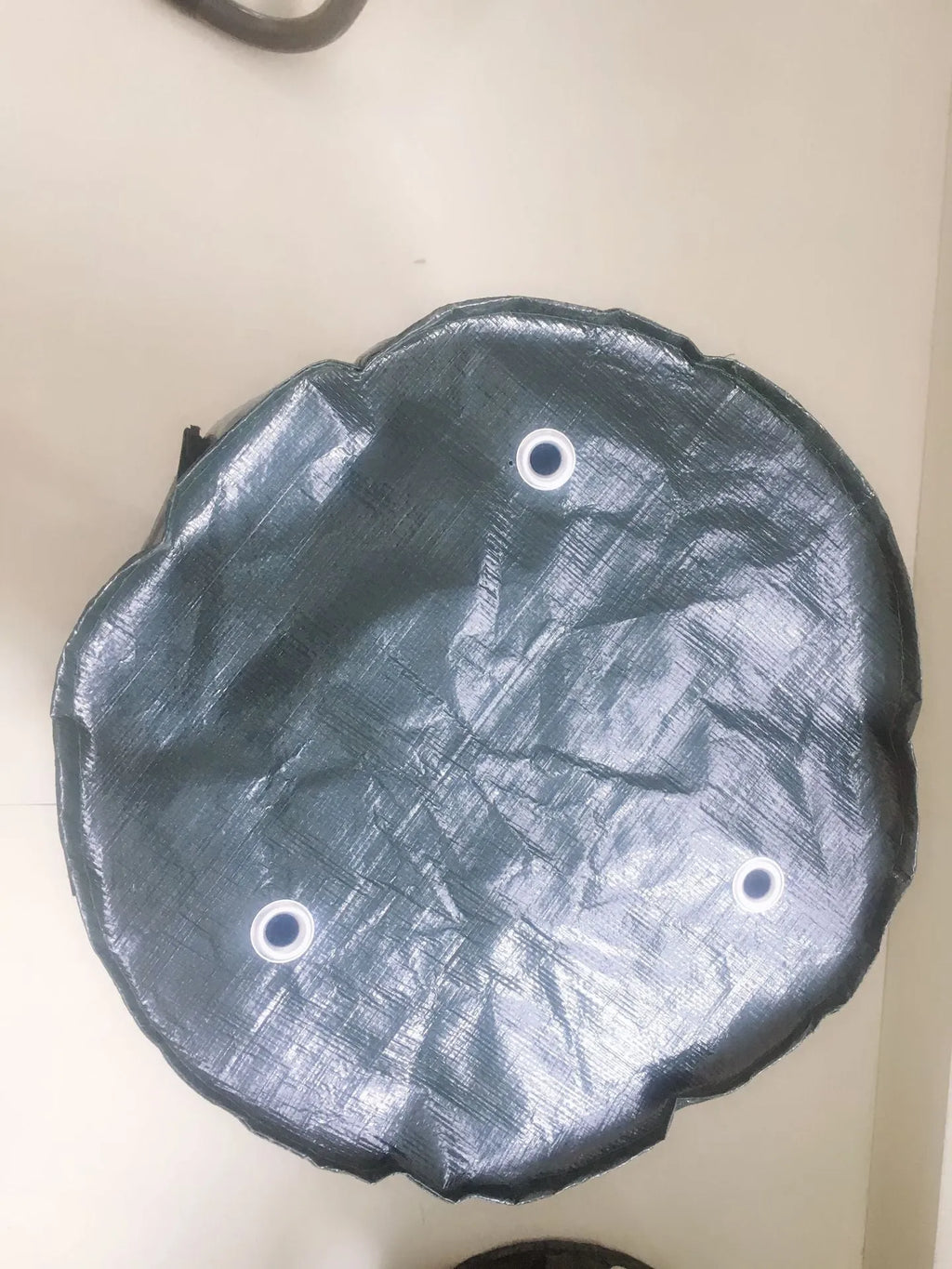 Dark green PE cloth garden planting bag with side windows and double handles on a balcony