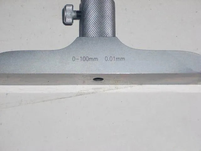 Precision depth micrometer tool with 0-100 mm range and 0.01 micrometre resolution.