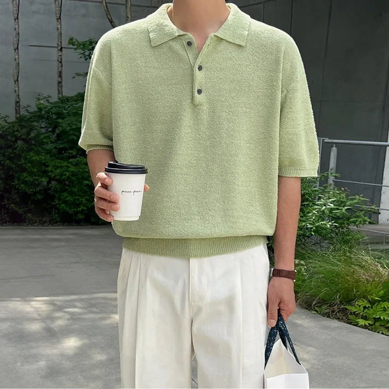 Man modelling a caramel coloured loose-fit knitted short sleeve polo shirt with an asymmetric design.