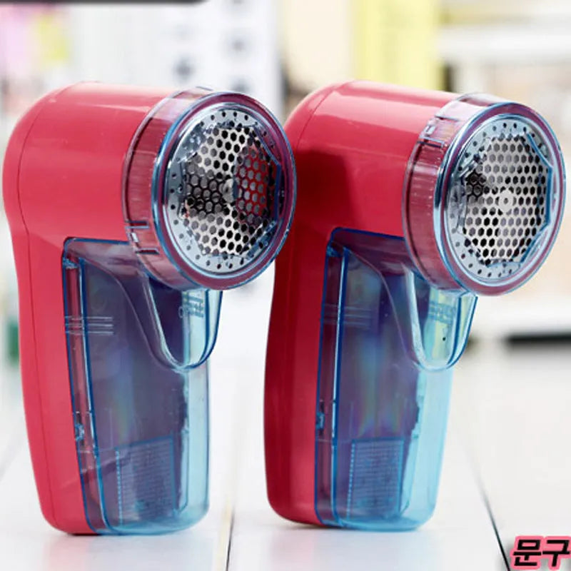 Portable electric clothing lint remover and fabric shaver on a white background.
