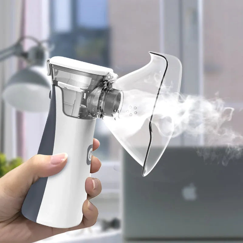 White handheld microporous medical nebuliser with mouthpiece, compact size 50x48x130mm