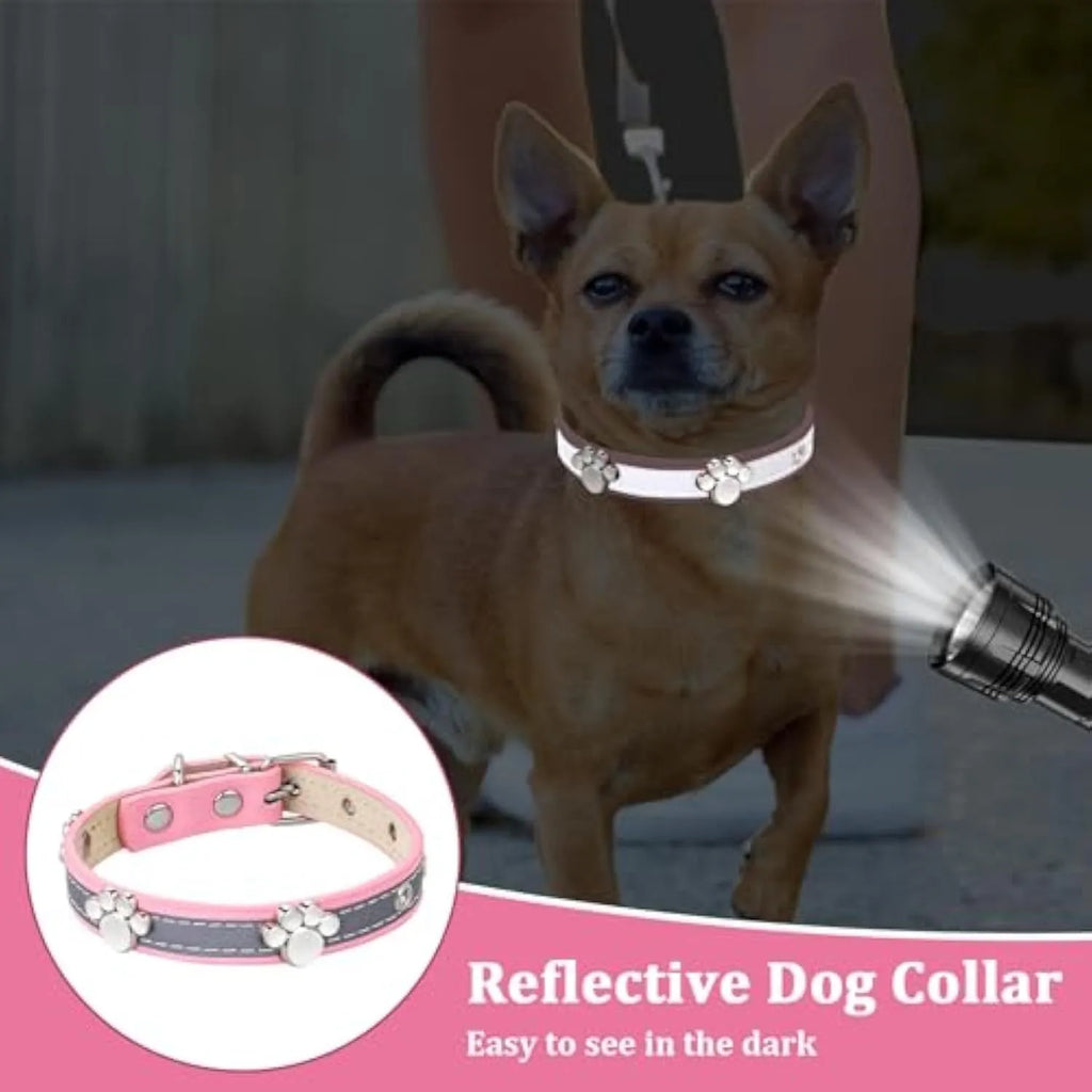 Reflective soft PU leather dog collar with metal buckle and decorative paw print rivets on a grey background.