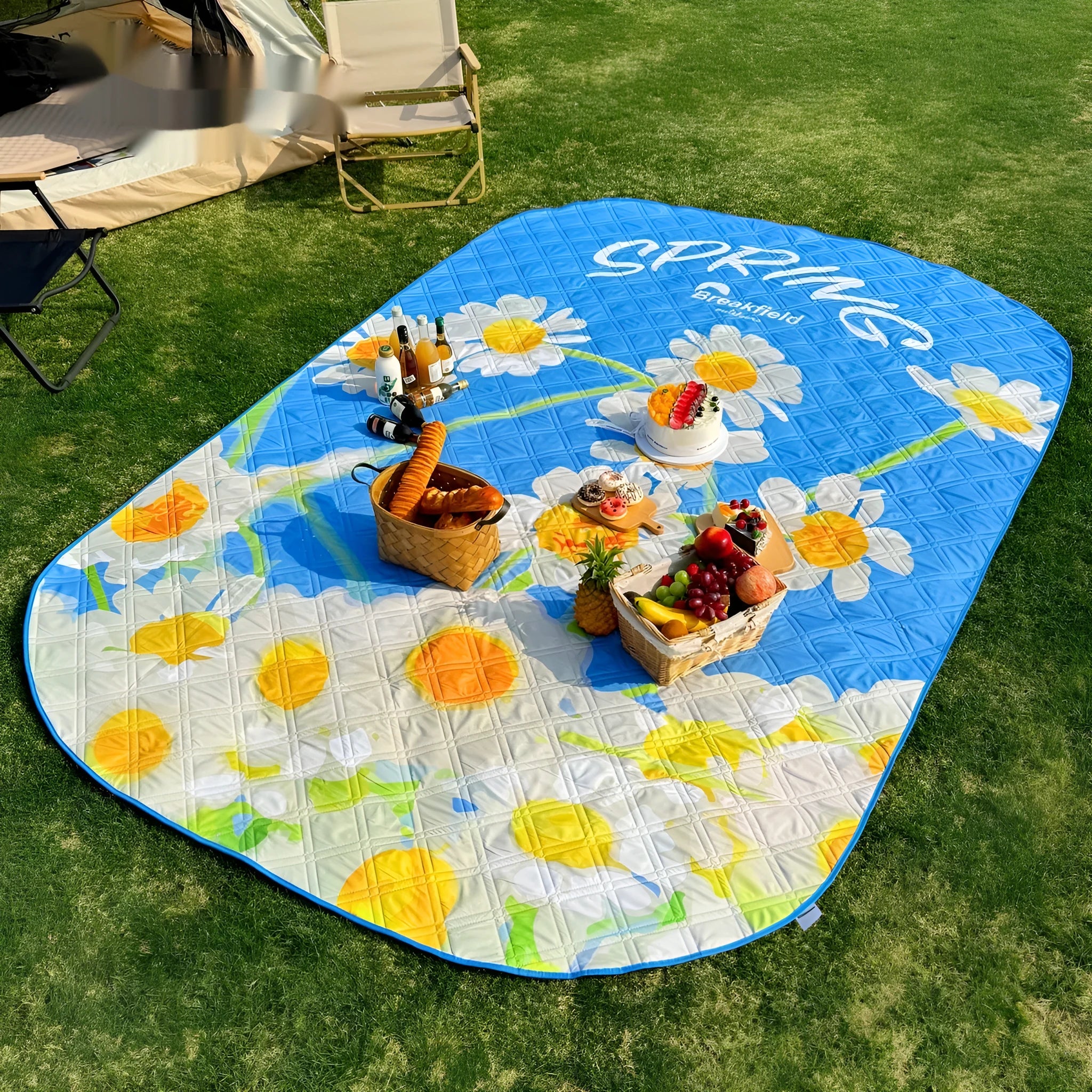 Waterproof thickened outdoor picnic mat in a seasonal colour, laid out on grass.