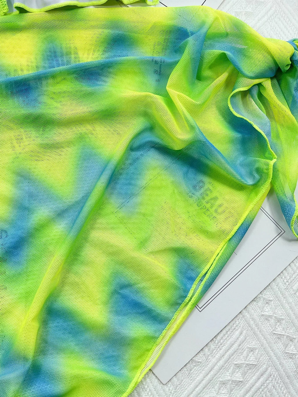 Green tie-dyed women's bikini swimsuit with an outer skirt.