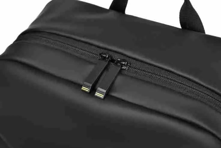 Men's large black waterproof PU backpack showing sewing thread detail and separate computer bag.