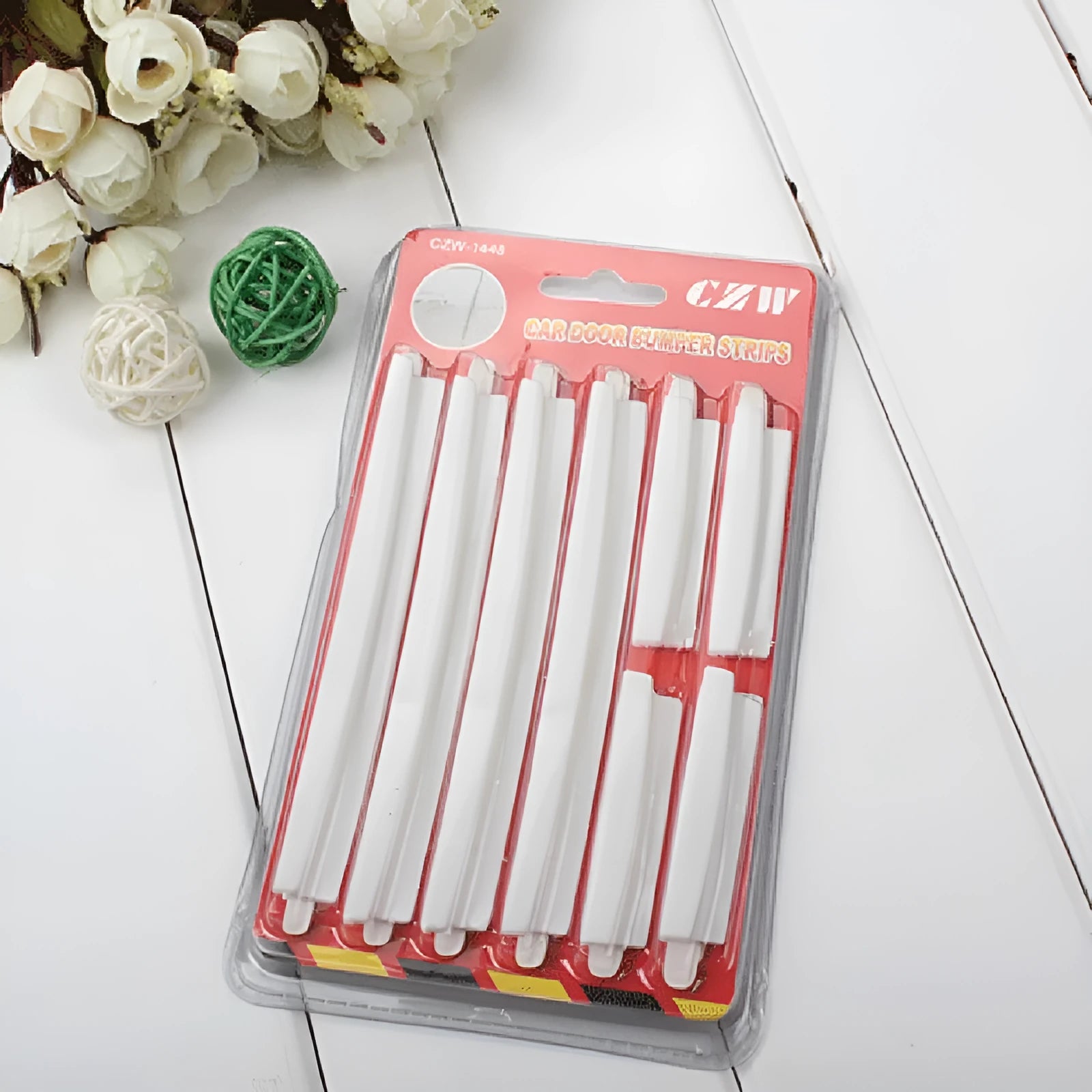 White plastic car door edge protector bumper strip set on a car door.