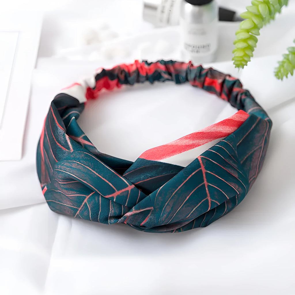 Red cloth headband for women with a banana leaf and cross pattern, showing elastic band.