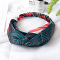 Red cloth headband for women with a banana leaf and cross pattern, showing elastic band.