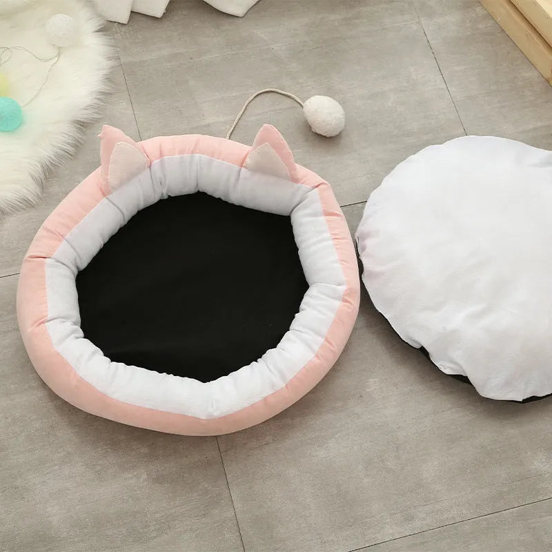 Round suede cat mat in pink grey with cat ear shape, 36cm diameter, on a light floor