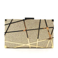 Gold glitter evening clutch bag with metal chain and lock closure on a table