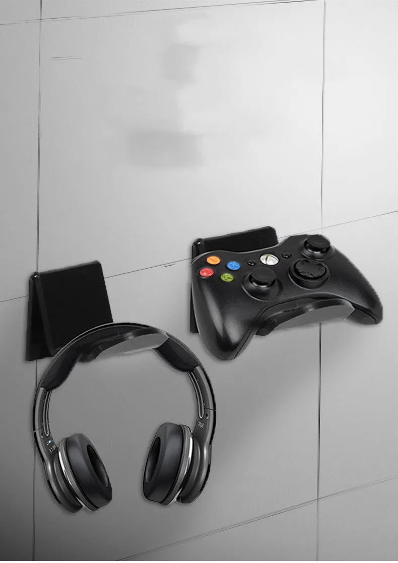 Plastic wall mounting bracket for video game controllers in black, white, or transparent finish.