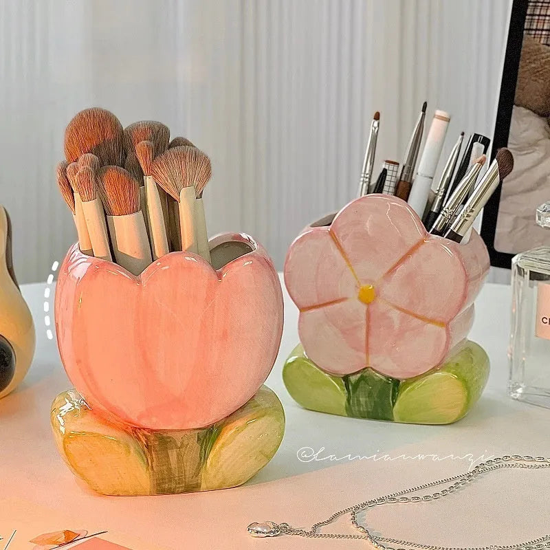 Ceramic tulip-shaped pen holder and storage box in a floral colour pattern on a desk.