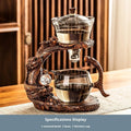 Green gray walnut glass automatic tea set with bowl, base, and fair cup on a table