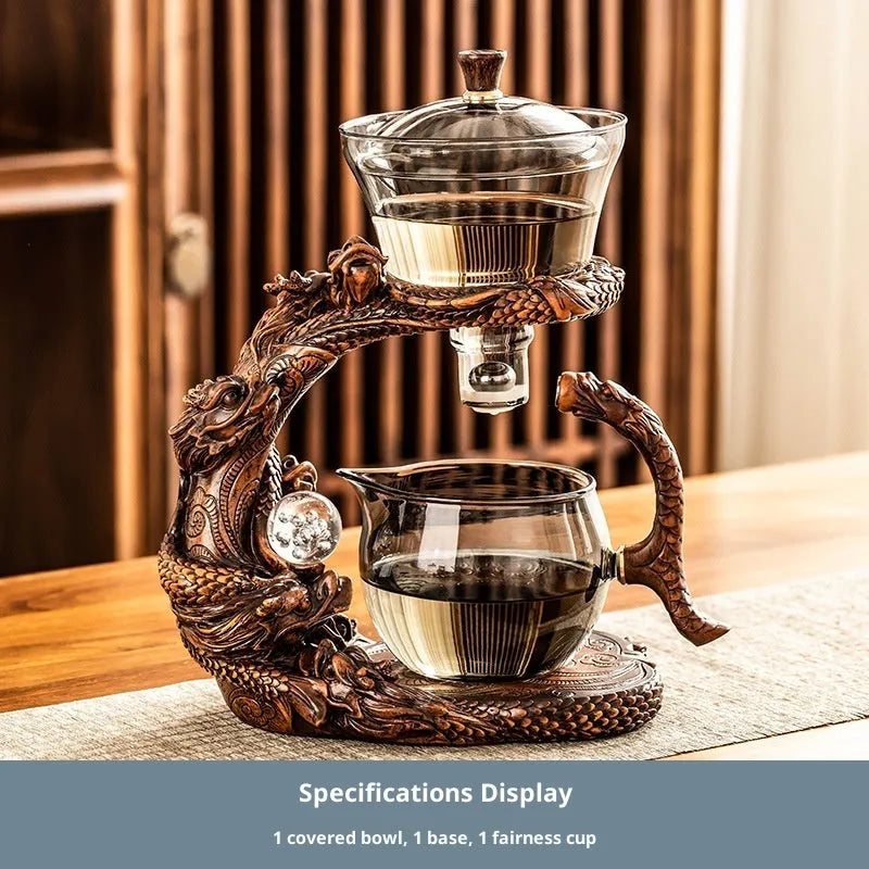 Green gray walnut glass automatic tea set with bowl, base, and fair cup on a table
