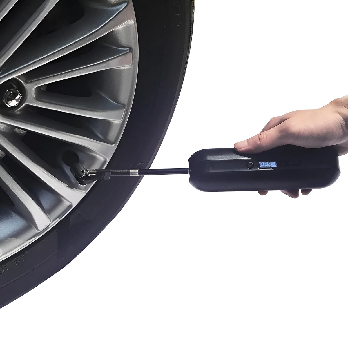 White portable electric tyre inflator with accessories on a non-slip mat, showing compact size and USB cable