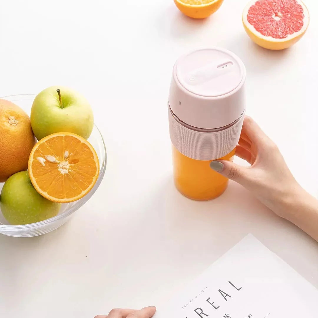 Wireless Charging Portable Mini Juicer Cup in pink and blue, compact and convenient for healthy juice on the go