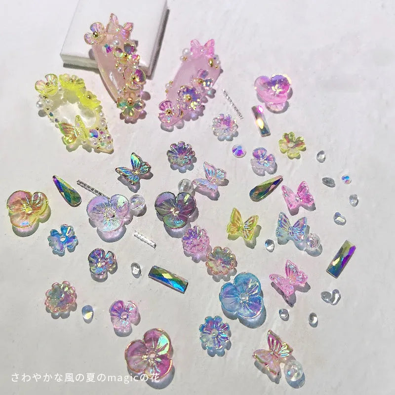 Container of flower and butterfly shaped nail sequins in mixed colours blue champagne grey pink transparent yellow