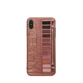 Flesh and grey silicone phone case for various iPhone models on a table.