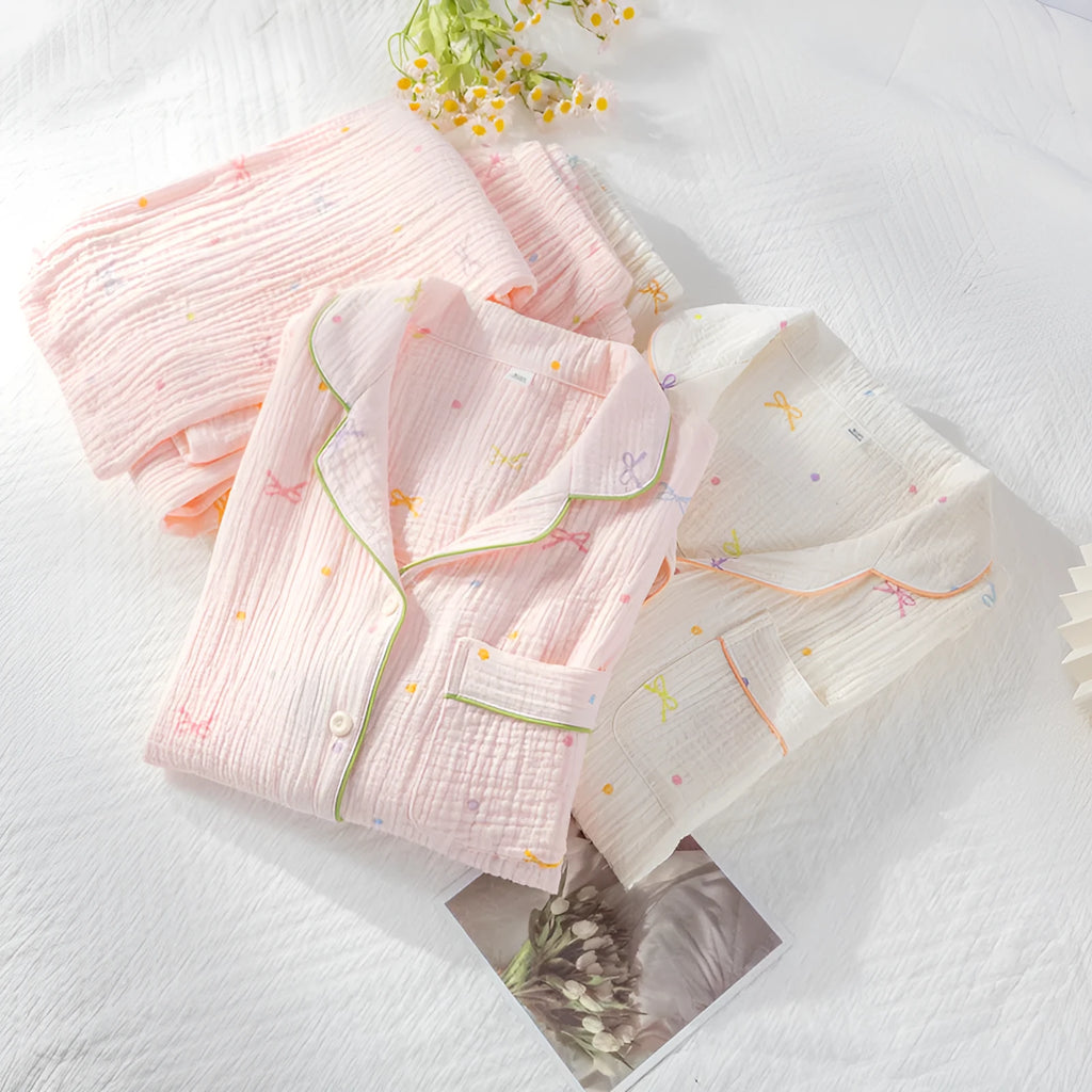 Beige and pink women's long-sleeved cotton pajama set with trousers on hanger.